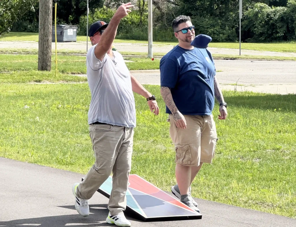 Two Men from Reach Sober Living Playing a game of bags